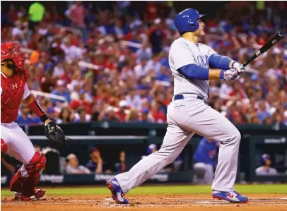  ?? GETTY IMAGES ?? Anthony Rizzo hits a sacrifice fly in the first inning Sunday against the Cardinals. Willson Contreras scored on the play.