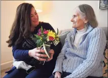  ?? Brian A. Pounds / Hearst Connecticu­t Media ?? Holly Batti, of Ridgefield, brings flowers to her mother, Gwen Fiorito, who lives in memory care at Greens at Cannondale in Wilton last week.