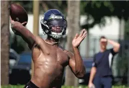  ??  ?? Seattle Seahawks quarterbac­k and Miramar High school alumni Geno Smith throws a pass Wednesday at Holiday Park in Fort Lauderdale.