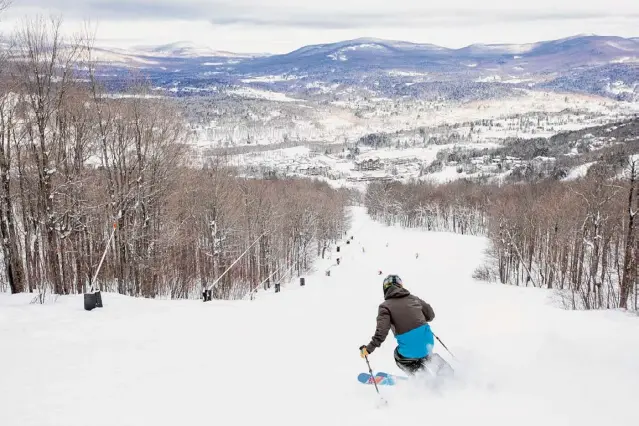  ?? Courtesy Windham Mountain ?? A skier heads down Windham Mountain. The resort owners plan to offer private membership­s and limit skiers at the Greene County mountain resort.