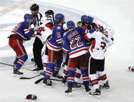  ?? — AP ?? NEW YORK: Referee Shane Heyer (55) tries to separate New York Rangers’ Chris Kreider (20) and Ottawa Senators’ Alex Burrows (14) as the remaining referees attempt to break up a fight during the third period of Game 4 of an NHL hockey Stanley Cup...