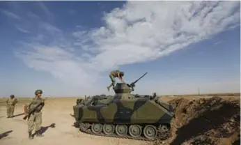  ?? MURAD SEZER/REUTERS ?? A Turkish soldier climbs into an armoured personnel carrier Thursday as his unit stands guard on the Turkish-Syrian border.