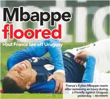  ??  ?? France’s Kylian Mbappe reacts after sustaining an injury during a friendly against Uruguay yesterday. –