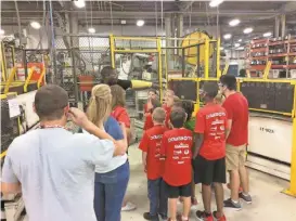  ??  ?? Northside Elementary students got a chance to take a look at how some industrial robots worked at several plants during their Dawgbot camp in June, including Miura, Jefferson Southern, Georgia Power and Kimoto Tech. In the above contribute­d photo,...