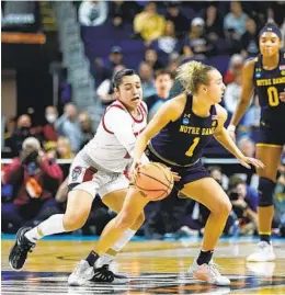  ?? FRANK FRANKLIN II AP ?? North Carolina State guard Raina Perez (left) strips the ball from Notre Dame guard Dara Mabrey for a steal late in the fourth quarter on Saturday.