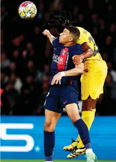  ?? — AFP file photo ?? Paris Saint-Germain’s forward Mbappe (LEFT) and Barcelona’s defender Jules Kounde fight for the ball during the UEFA Champions League quarter final first leg match at the Parc des Princes stadium in Paris.