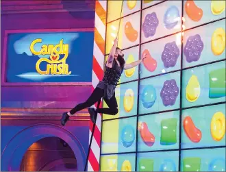  ?? Associated Press photo ?? This image shows a contestant competing in the new game show “Candy Crush.”