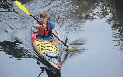  ?? JIM DAY/THE GUARDIAN ?? Sixteen-year-old Jo Simmons paddles his sea kayak in the Bonshaw River near his home. Simmons recently paddled around P.E.I. in under two weeks, camping each night close to the shoreline.