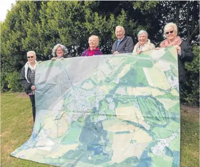  ??  ?? Kincardine residents with a carpet map of their village as a study is carried out into its future following Longannet power station’s closure. From left, Pauline Douglas, Janice McLaughlin, Lesley Gavin, Willie Anderson, Mary Harley and Enid Trevett
