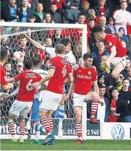  ??  ?? HIGH-RISE AND HANDSOME: Angus Macdonald heads the Barnsley equaliser