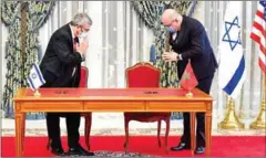  ?? AFP ?? Representa­tives of Israel and Morocco greet each other before signing an agreement at the Royal Palace in the Moroccan capital Rabat.