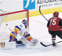  ?? ROSS D. FRANKLIN / THE ASSOCIATED PRESS ?? Arizona Coyotes centre Nick Cousins scores an OT gamewinner against Islanders goaltender Jaroslav Halak.