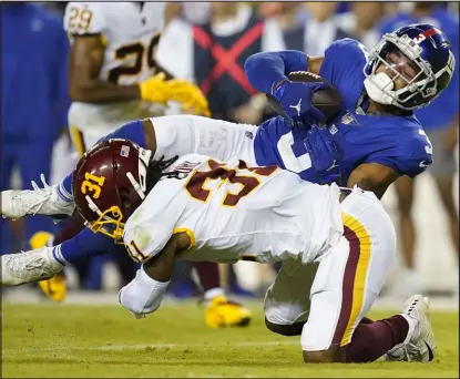  ?? Patrick Semansky The Associated Press ?? New York Giants receiver Sterling Shepard is tackled by Washington’s Kamren Curl on Thursday.