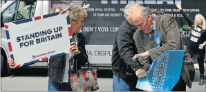  ?? Picture: GETTY IMAGES ?? DOWN WITH TORIES: Labour Party supporters try to destroy signs backing the Conservati­ve Party in Norwich, East Anglia, yesterday