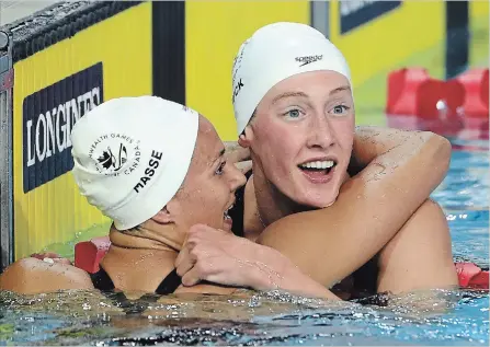  ?? ASSOCIATED PRESS FILE PHOTO ?? Kylie Masse of LaSalle, Ont., left, embraces third-place finisher Taylor Ruck of Kelowna, B.C., after winning the women’s 100-metre backstroke final at the Commonweal­th Games in April in Australia. Masse and Ruck are two of Swimming Canada’s brightest young stars.