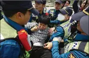  ?? CHUNG SUNG-JUN / GETTY IMAGES ?? South Korean policemen drag out an activist who opposes releasing balloons containing leaflets denouncing North Korean leader Kim Jong-Un during a rally on Saturday in Paju, South Korea.