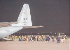  ?? VISAR KRYEZIU/AP ?? Families evacuated from Afghanista­n walk past a U.S Air Force plane Aug. 29 that they arrived on at Pristina Internatio­nal Airport in Kosovo.