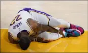 ?? MARCIO JOSE SANCHEZ - THE ASSOCIATED PRESS ?? Los Angeles Lakers forward LeBron James holds his ankle after going down with an injury during the first half of an NBA basketball game against the Atlanta Hawks Saturday, March 20, 2021, in Los Angeles.