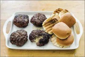  ?? DANIEL J. VAN ACKERE — AMERICA’S TEST KITCHEN VIA AP ?? This undated photo provided by America’s Test Kitchen in May 2018 shows Jucy Lucy burgers in Brookline, Mass. This recipe appears in “The Complete Cook’s Country TV Cookbook, 2017.”