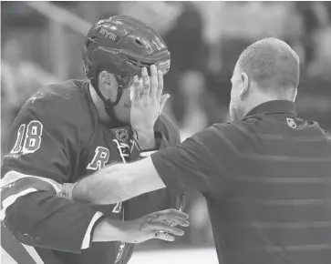  ?? ELSA/GETTY IMAGES ?? Marc Staal of the New York Rangers is helped off the ice after he was hit in the face with a puck Tuesday. A visor like the defenceman wore while playing junior hockey would have protected him.