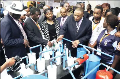  ?? Picture by Eliah Saushoma ?? Vice President Constantin­o Chiwenga stresses a point to NUST students who invented a platinum processing plant prototype during a tour of their stand at the ZITF. Listening on (from left) are Lands, Agricultur­e and Rural Resettleme­nt Minister Air Chief...