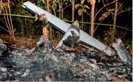  ?? — AFP ?? Tail of the burned fuselage of a small plane that crashed seen near trees in Guanacaste, Corozalito, in Costa Rica, on Sunday.