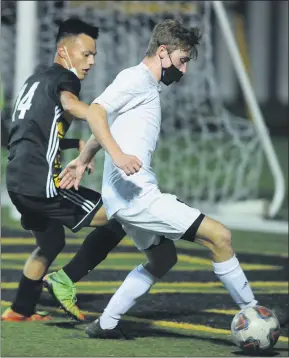  ?? PHOTOS BY KEN SWART — FORMEDIANE­WS GROUP ?? Above: Brennan Cannaday (right) controls the ball in front of Bishop Foley’s Corbin Grobbel during the CHSL match played on Monday at Bishop Foley. Cannaday had a goal to help lead the Knights to a 4-0win. Below: Bishop Foley’s Greg Altman (right) gets a leg up on Shrine Catholic’s Beck Peaslee (21) during the CHSLmatch played on Monday.