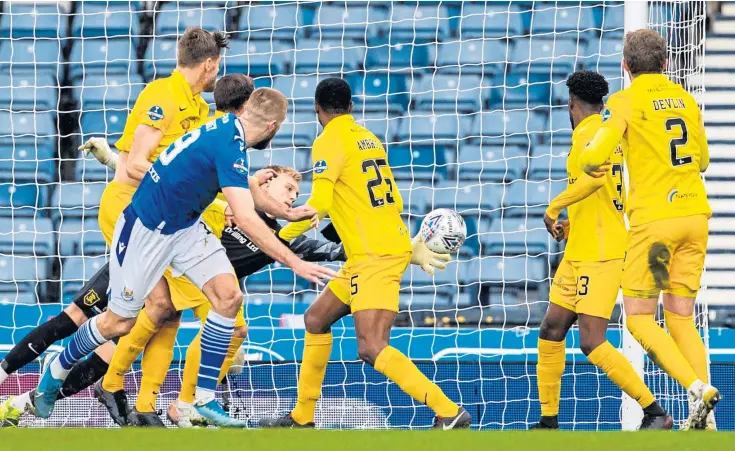  ??  ?? HEADING FOR GLORY: Shaun Rooney beats Livingston keeper Ross McCrorie to make it 1-0 and set Saints on their way to victory at Hampden.