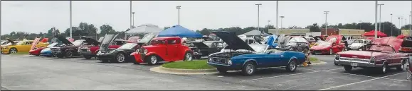  ?? (NWA Democrat-Gazette/Susan Holland) ?? A wide array of vehicles sits in the parking lot at Lion Stadium beside Gravette High School on Aug. 20 during the benefit car show hosted by Gravette Cruise. The show attracted 93 entries, and proceeds benefited Gravette Bright Futures.