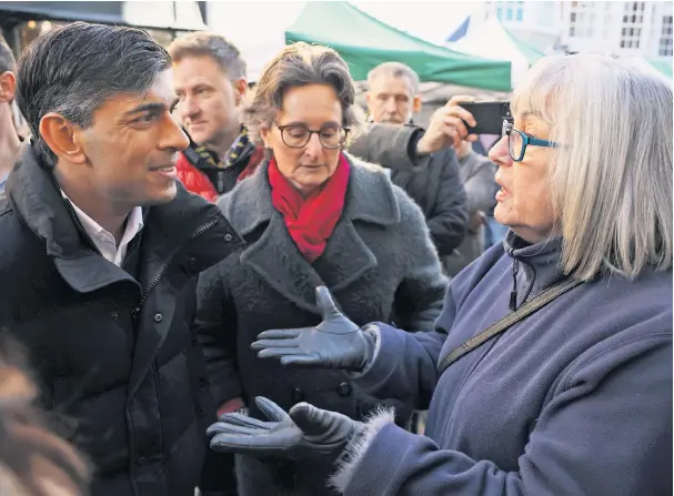  ?? ?? Rishi Sunak is confronted by a member of the public over the state of the NHS and his handling of strike action during a walkabout in Winchester