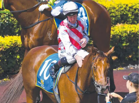  ?? Picture: AAP IMAGE ?? Jockey Jim Byrne, pictured patting Khalama after a victory at Doomben on Saturday, is unlikely to back up on the Gold Coast today.