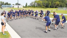  ?? JEFFREY F. BILL/BALTIMORE SUN MEDIA PHOTOS
ABOVE: ?? TOP: Virginia Hernandez, center, completes a set of lunges. The entire recruitmen­t class cheers after joining a classmate — encouragin­g him to complete 50 squats during physical fitness activities. The 91st recruitmen­t class is the most diverse recruiting class in the history of the Anne Arundel County Police Academy.