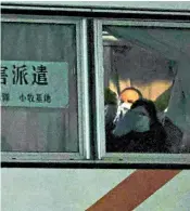  ??  ?? British passengers wearing face masks on a bus from the quarantine­d cruise liner depart Yokohama on their way to board a flight back to the UK. They are due to arrive in Wiltshire this morning