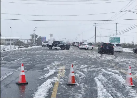  ?? Photo courtesy of California Highway Patrol ?? Heavy traffic tries to maneuver Thursday through the snow, slush and ice on State Route 58 Business on the north side of Mojave after State Route 58 going over the Tehachapi Pass was closed. Much of the Antelope Valley received at least a few inches of snow Thursday. It started falling in the early morning hours.