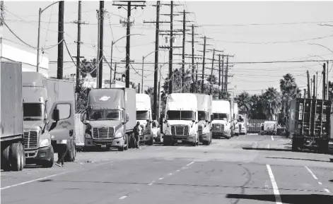  ?? AP PHOTO/RINGO H.W. CHIU ?? Parked cargo container trucks are seen in a street, on Wednesday in Wilmington, Calif.