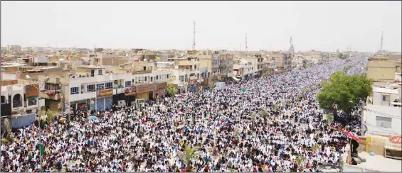  ?? ?? Followers of Shiite cleric Muqtada al-Sadr chant slogans during an open-air Friday prayers in Sadr City, Baghdad, July 15, 2022. Residents of the impoverish­ed Baghdad suburb of Sadr City say they support al-Sadr, an influentia­l cleric who called on thousands of his followers to storm Iraq’s parliament. (AP)