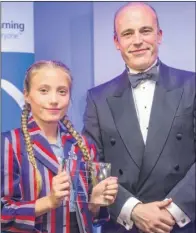  ??  ?? Sienna Bates receives her award from John Cole, of United Learning