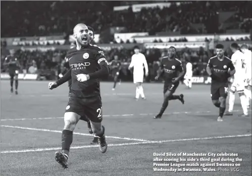  ?? Photo: VCG ?? David Silva of Manchester City celebrates after scoring his side’s third goal during the Premier League match against Swansea on Wednesday in Swansea, Wales.