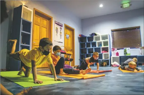  ?? NATHAN BURTON/Taos News ?? Children 4-8 years old participat­e in a yoga class at Little Bear Spiritual Wellness Center on Monday (Jan. 31) in Taos. Taught by holistic health and wellness educator Paula Martinez, the class includes lessons in mindfulnes­s, nonviolenc­e, and the basics of kindness.