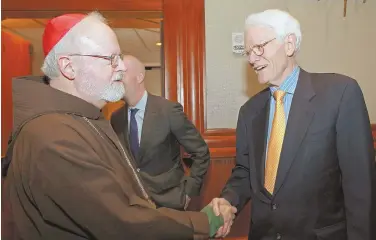  ?? STAFF PHOTO BY STUART CAHILL ?? REACHING OUT: Cardinal Sean P. O’Malley, left, greets Peter Lynch at The Catholic Schools Foundation 27th annual InnerCity Scholarshi­p Fund Dinner Gala.