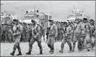  ?? AP/SHAKH AIVAZOV ?? Georgian servicemen train at a base near the town of Gardabani as they prepare to leave for duty in Afghanista­n as part of the internatio­nal mission there.