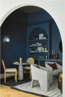  ?? DGI DESIGNS ?? This home features a cozy alcove in inky blue to accentuate the curved ceiling and intimate space.