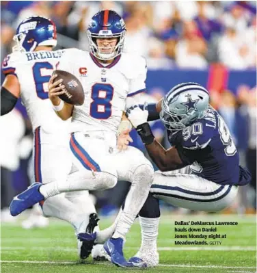  ?? GETTY ?? Dallas’ DeMarcus Lawrence hauls down Daniel Jones Monday night at Meadowland­s.