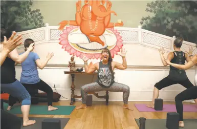  ?? Photos by Liz Hafalia / The Chronicle 2019 ?? Jane Austin, above, instructs a prenatal yoga class last year at San Francisco’s Yoga Tree Valencia, below. Yoga Tree’s CEO says the Bay Area studios will not reopen while social distancing restrictio­ns are in place.