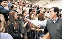  ?? JOHN GRESS/REUTERS PHOTO ?? Rick Santorum campaigns Tuesday at a school assembly in Urbandale, Iowa. He says he won’t skip New Hampshire, unlike some rivals.