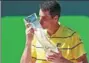  ?? USA TODAY SPORTS ?? John Isner kisses the trophy after winning the Miami Open on Sunday.