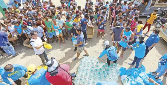  ??  ?? Operation Damayan, the social arm of The Philippine STAR led by its president and CEO Miguel Belmonte, visits San Pascual to distribute relief bags to families in evacuation centers displaced by the eruption of Taal volcano. PhotobyWAL­TERBOLLOZO­S