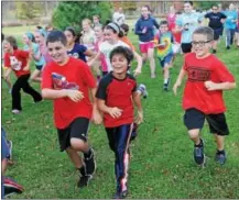  ?? JOHN STRICKLER — 21ST CENTURY MEDIA ?? More than 300Owen J. Roberts elementary school students participat­ed in the Wildcat Run held at Warwick Park. The popular run was organized by OJR High School and its varsity cross country team. Smiling runners take off from the starting line.