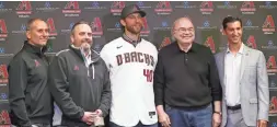  ?? MICHAEL CHOW/THE REPUBLIC ?? Madison Bumgarner (center) poses for a photo with (from left) Arizona Diamondbac­ks manager Torey Lovullo, team president Derrick Hall, owner Ken Kendrick and general manager Mike Hazen on Tuesday.