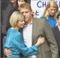  ?? Tyler Sizemore / Hearst Connecticu­t Media ?? Scott Hapgood, of Darien, hugs his wife, Kallie Hapgood, at Town Hall in Darien as U. S. Sen. Richard Blumenthal, D- Conn., and the town show support for him in his manslaught­er charge from a family vacation in Anguilla in October. Hapgood is facing a manslaught­er charge in connection with the death of a man who the family says attacked Hapgood in his hotel, forcing him to defend himself and his family.